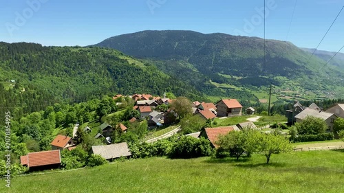 Bosnia Herzegovina pan across rural village green valley mosque farms