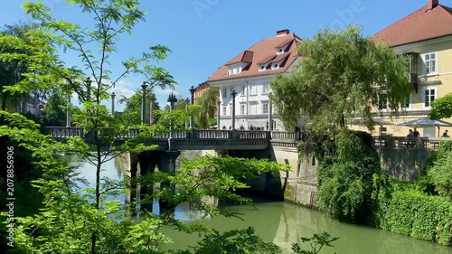 Ljubljana pan across bridge and river in city centre Slovenia