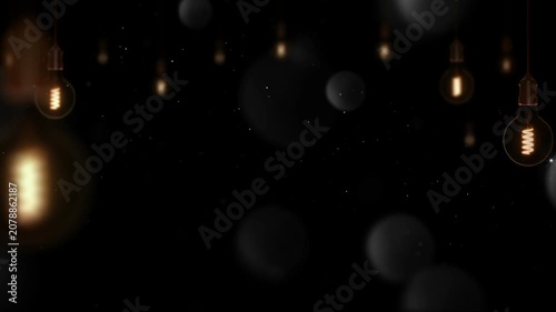 Edison bulbs hang in a dark space illuminating the surrounding air with warm glowing filaments.