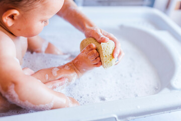 Mother bathing her little son