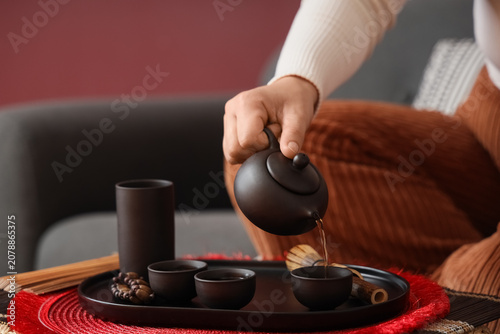 Woman pouring Asian tea int...
