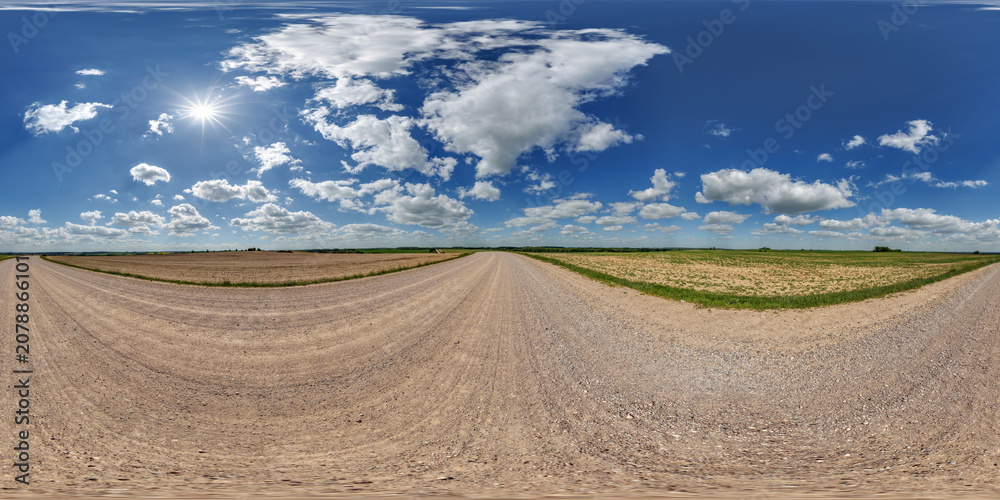 Obraz premium blue sky hdri 360 panorama with awesome clouds on gravel road among fields in spring day in equirectangular full seamless spherical projection, for VR AR content or skydome replacement