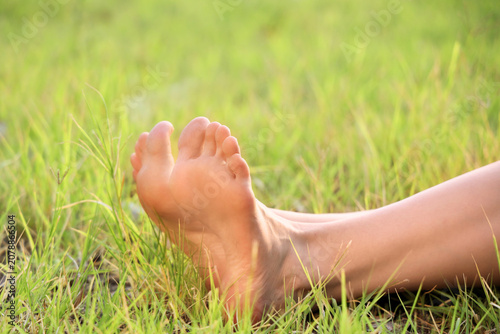 Barefoot young woman lying ...