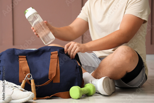 Man with bottle of water an...