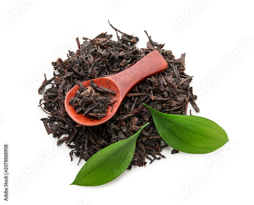 Spoon with dry black tea an...