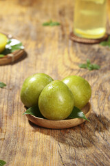 Fresh Green Olives on Wooden Plate with Olive Oil and Lemon - Mediterranean Food Still Life Studio Photography