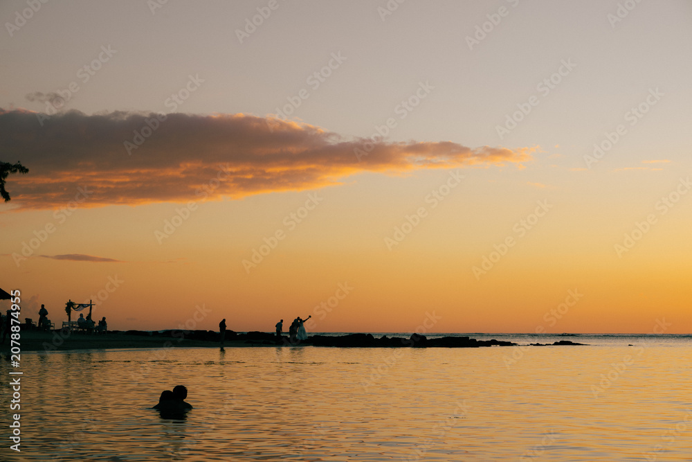 Fototapeta premium Group of people at sunset in Mauritius