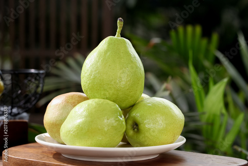 Fresh Fragrant Korla Pears from Xinjiang China on White Plate - Whole Crisp Green Fruit Display