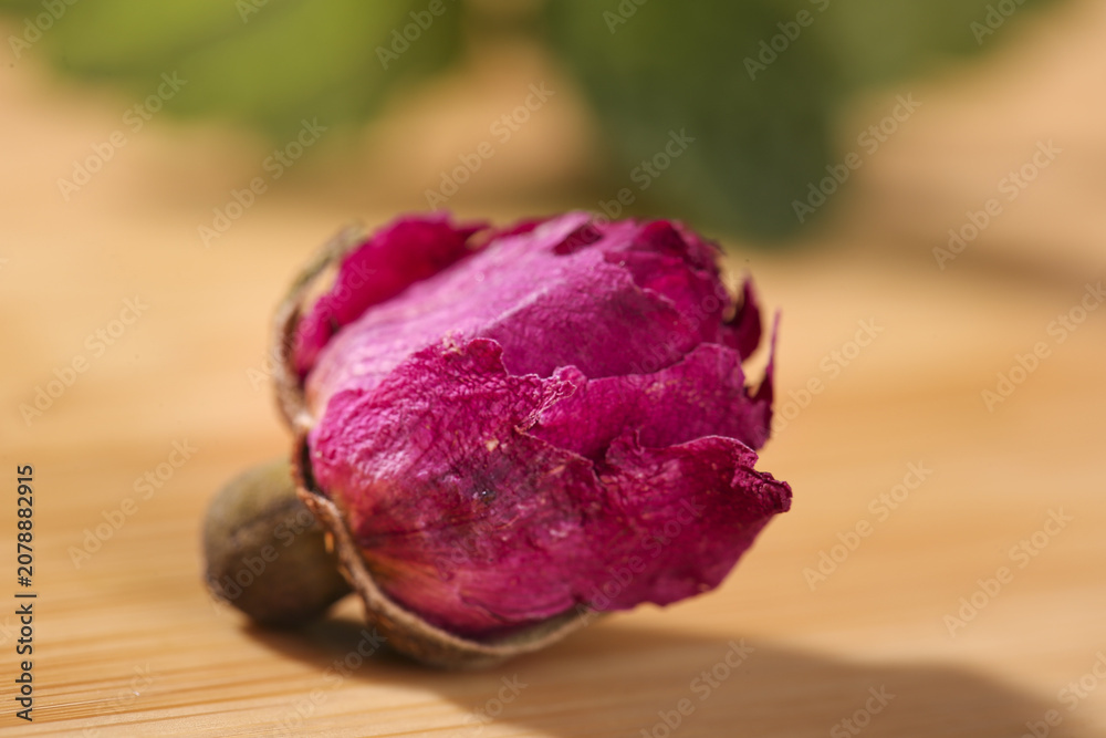Obraz premium Dried Rose Petals from Yunnan China in Wooden Spoon for Traditional Herbal Tea