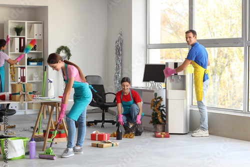 Team of young janitors clea...