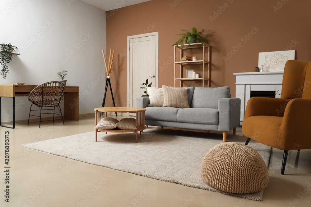 Fototapeta premium Interior of stylish living room with sofa, armchair and soft carpet