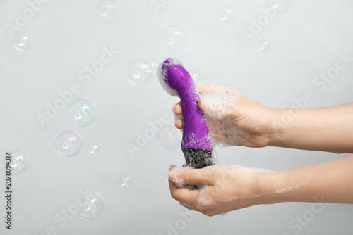 Woman washing purple vibrat...