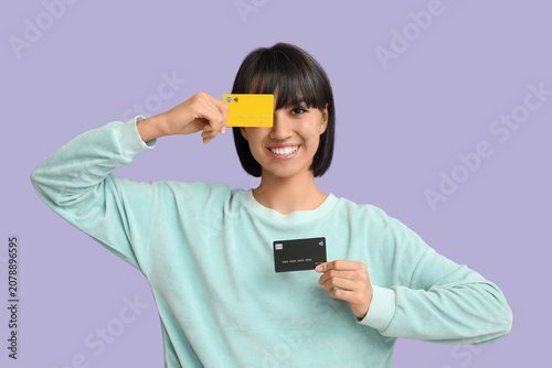 Happy young woman with cred...
