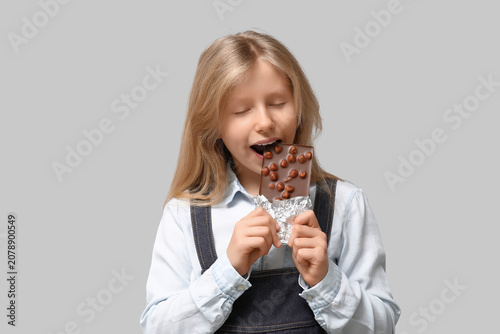 Cute little girl eating swe...