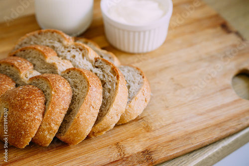 Freshly baked sourdough bread loaf with a crispy crust, partially sliced for eating