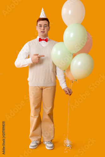 Young man in party hat with...