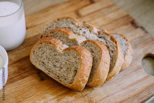 Freshly baked sourdough bread loaf with a crispy crust, partially sliced for eating