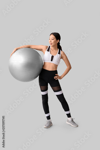 Sporty young Asian woman wi...