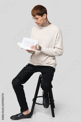 Young tattooed man with boo...