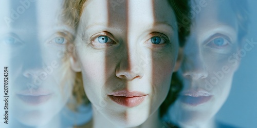 Close-Up Portrait of Woman with Multiple Reflections and Blue Eyes