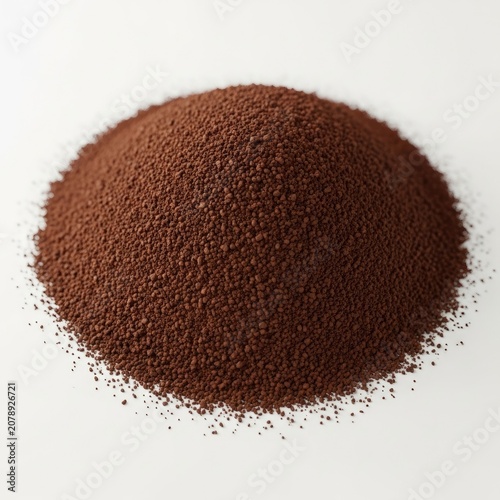 Pile of finely ground coffee powder on a white background.