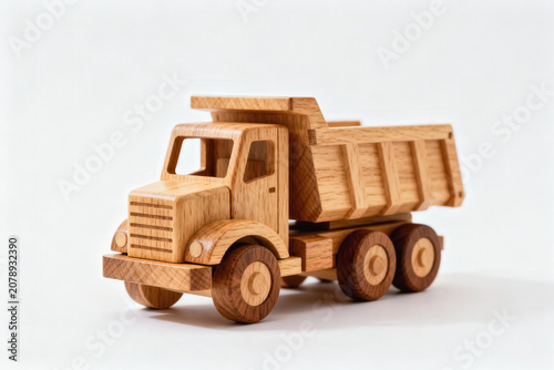 A handcrafted solid wooden miniature dump truck, designed as a classic toy for children, made of natural wood with no extra decorations.