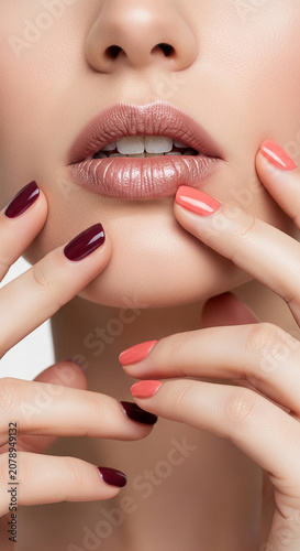 Close-up of woman's lips and nails with glossy polish, showcasing beauty, elegance, and meticulous care, symbolizing personal grooming and style