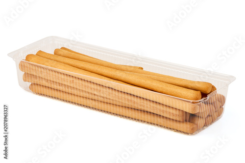 Crispy Breadsticks in a Clear Plastic Container on White Background
