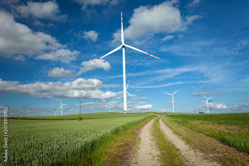 Dirt road towards wind turbines