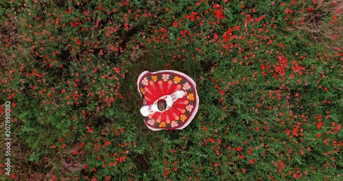 Woman Twirling in Traditional Folk Dress Among Blooming Poppy Field Top Down Aerial View