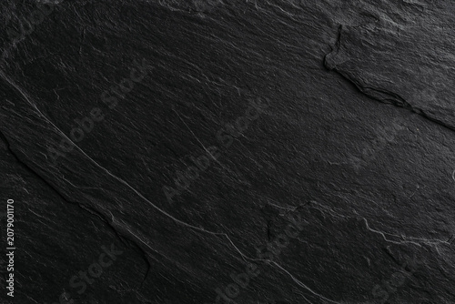 Dark black slate stone background with natural texture