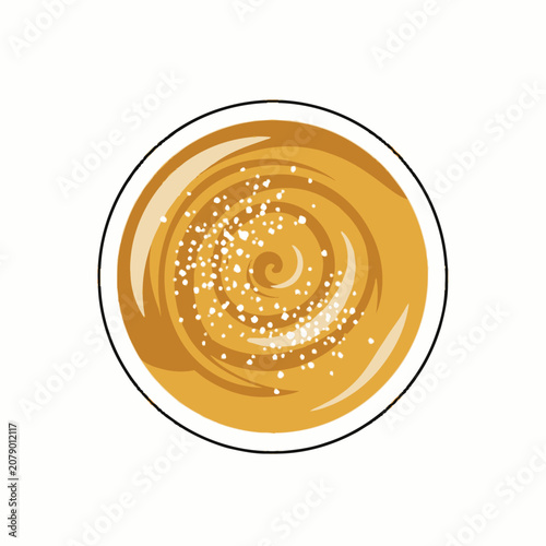 Topdown view of a delicious caramel latte with a swirl design and sugar sprinkles.