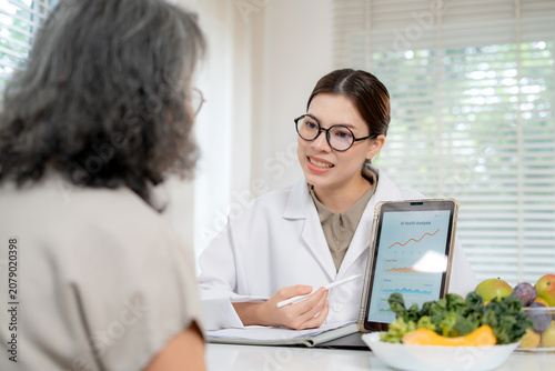 Asian nutritionist showing AI health analysis graph on tablet to senior patient, doctor using technology for medical data tracking, medical diagnosis for diet control, consulting and nutrition.