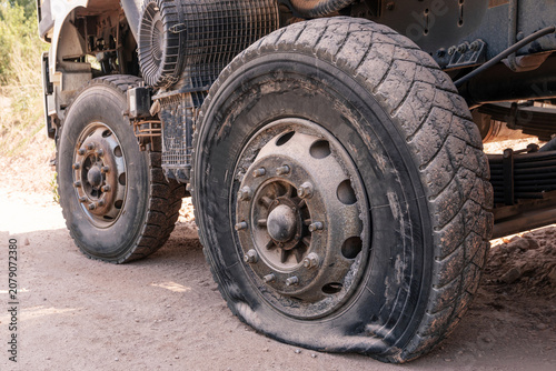 Flat tire on heavy duty truck at construction site, vehicle breakdown and equipment downtime