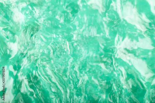 Turquoise water background. Abstract image of turquoise water surface featuring ripples and reflections, vibrant texture that captures light and movement of water in visually engaging manner