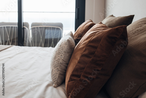 Different soft fur pillows on sofa in room