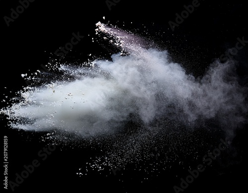 white powder explosion isolated on black background white dust particles splash