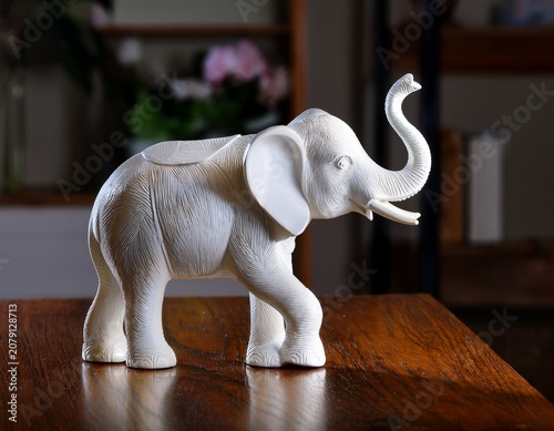 white porcelain figurine of an elephant stands on the table