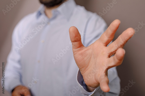 Konstfotografi Close-up of a man's hand reaching forward, suggesting an offer or plea