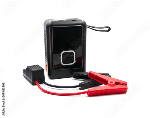 Portable car jump starter with booster cables isolated on white