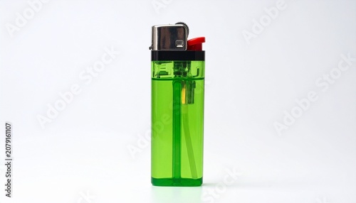 A green disposable lighter with metallic top and red ignition button, upright against a plain background, symbolizing everyday utility, modern design, and functionality for producing flame.