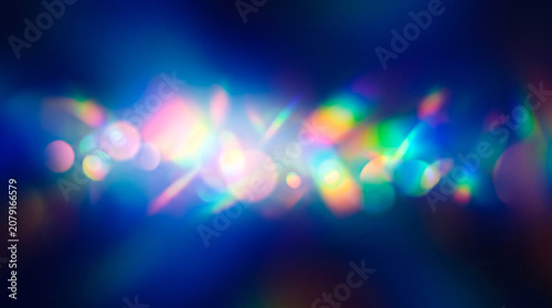 Colorful abstract bokeh light background with rainbow lens flare and glowing effects for creative design
