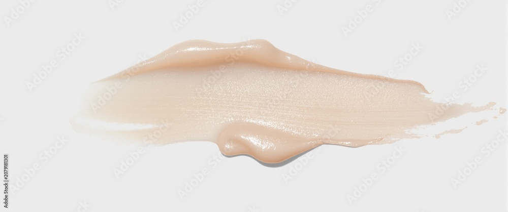Fototapeta premium Beige foundation cream smear on a white background