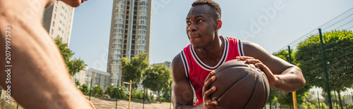 Young men enjoy summer street basketball on a vibrant outdoor court together