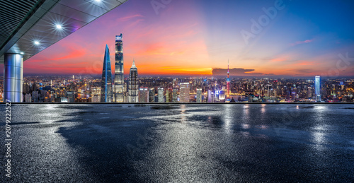 Night view of Shanghai skyline with skyscrapers and wet asphalt ground in China