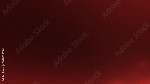 Red bokeh lights shimmering softly in a dark space