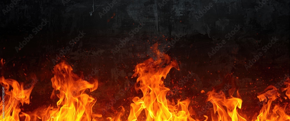 Fototapeta premium Flames against a dark background with sparks flying