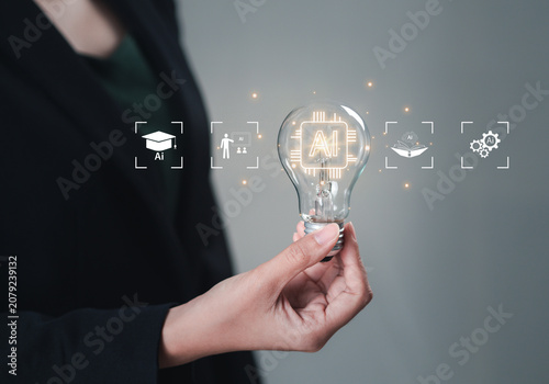A woman holds a light bulb in her hand for learning using artificial intelligence (AI), educational tools, video-based instruction, digital courses, internet lessons, and the concept of e-learning.