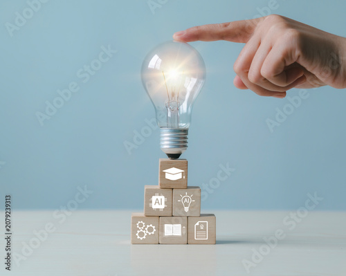 Wooden blocks with light bulbs, artificial intelligence (AI) learning, educational tools, video-based instruction, digital courses, online lessons, e-learning concepts.