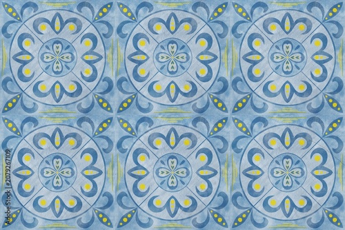 Decorative blue and yellow floral pattern illustration featuring intricate designs and symmetrical shapes arranged in a repeating tile format on a textured background